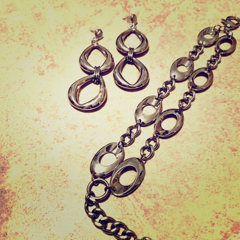 Silver-like earrings and bracelet.